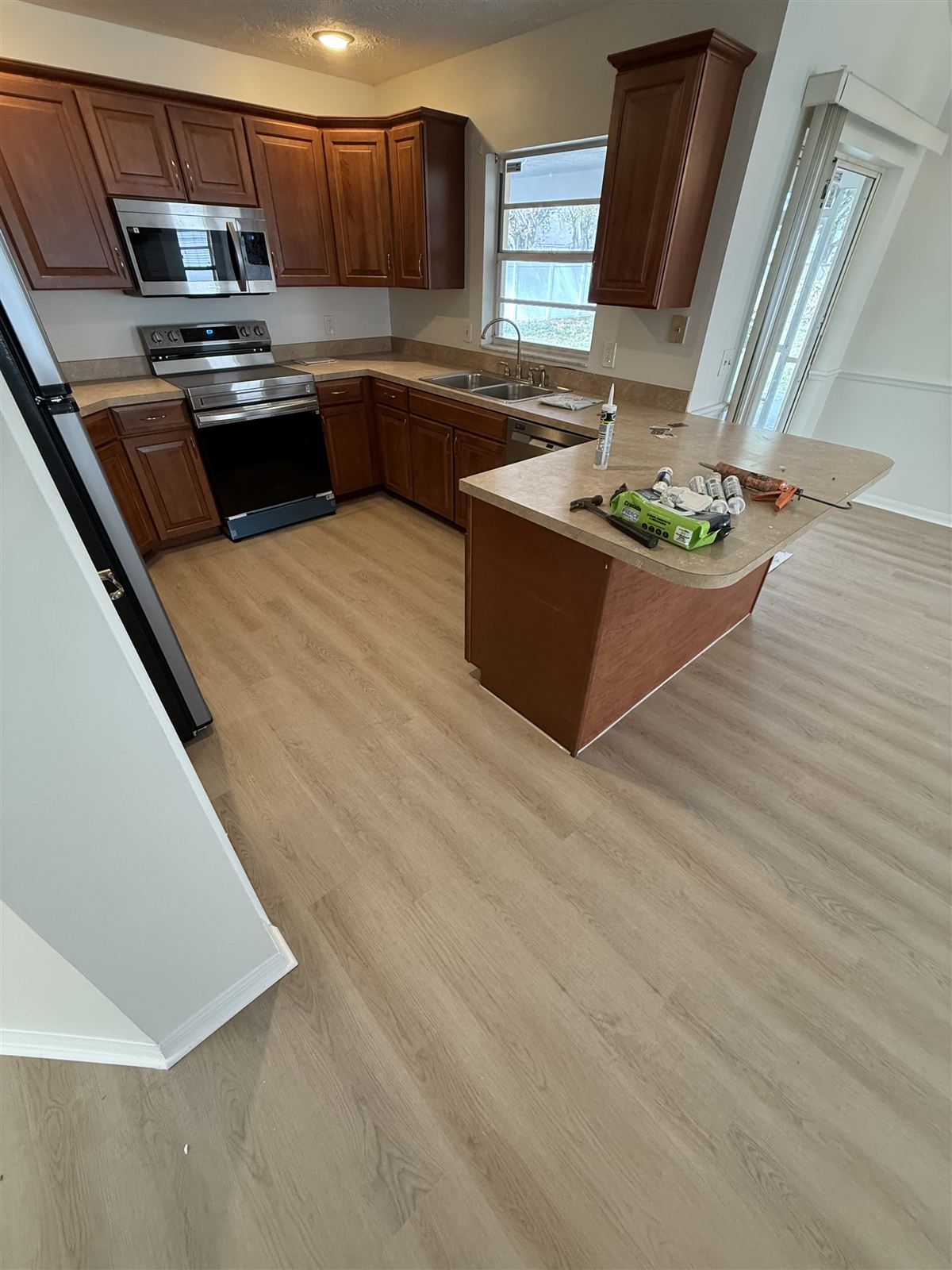 Wood cabinet kitchen remodel with island by 3DCON LLC in Brandon
